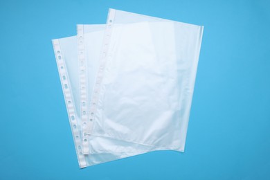 Punched pockets on light blue background, flat lay
