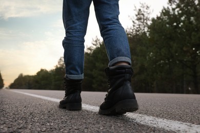 Woman going along road, closeup of legs