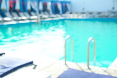 Photo of Blurred view of modern outdoor swimming pool on sunny day