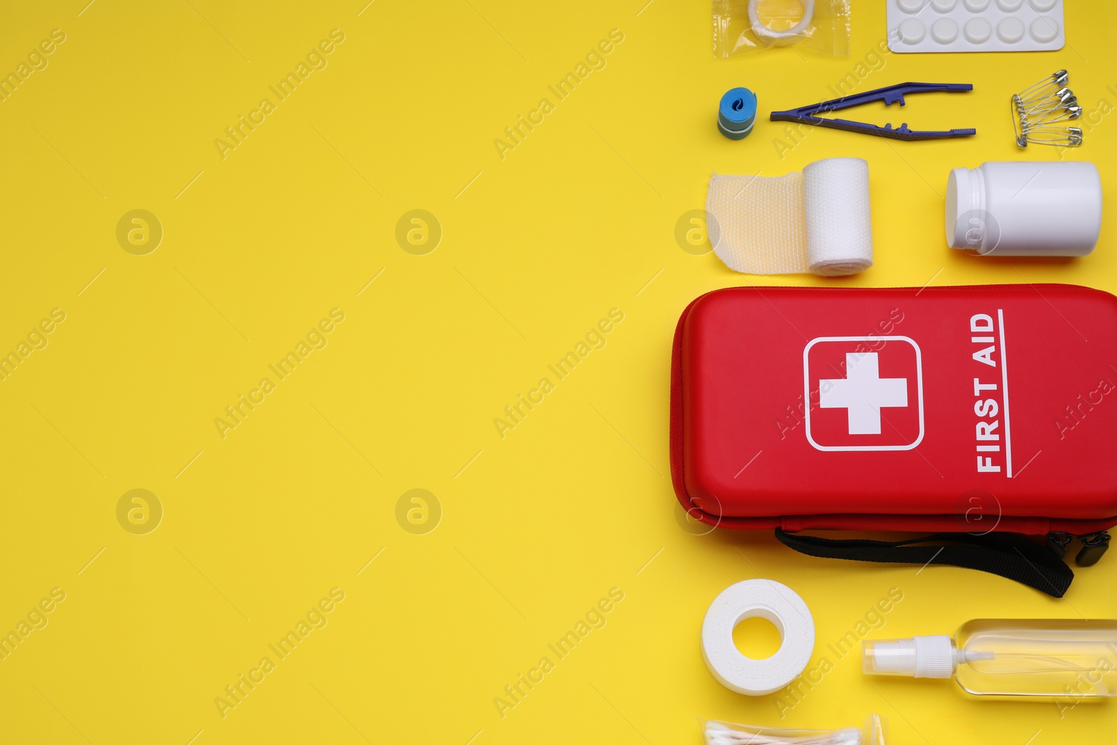 Photo of Flat lay composition with first aid kit on yellow background. Space for text