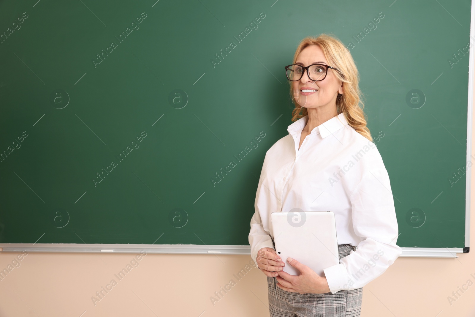 Photo of Happy professor with glasses near green board, space for text