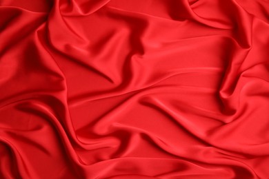 Photo of Texture of delicate red silk as background, top view