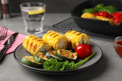 Photo of Delicious grilled vegetables served on grey table