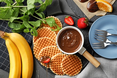 Photo of Flat lay composition with milk chocolate fondue on table