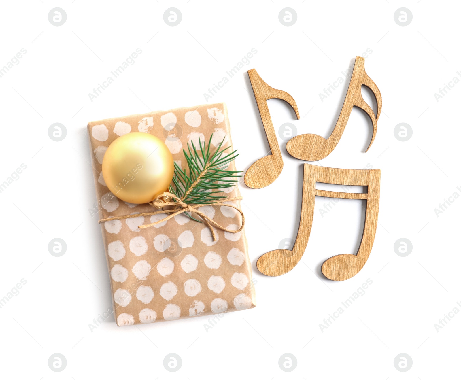 Photo of Wooden notes and gift box on white background. Christmas music concept