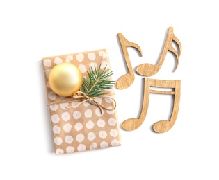 Photo of Wooden notes and gift box on white background. Christmas music concept