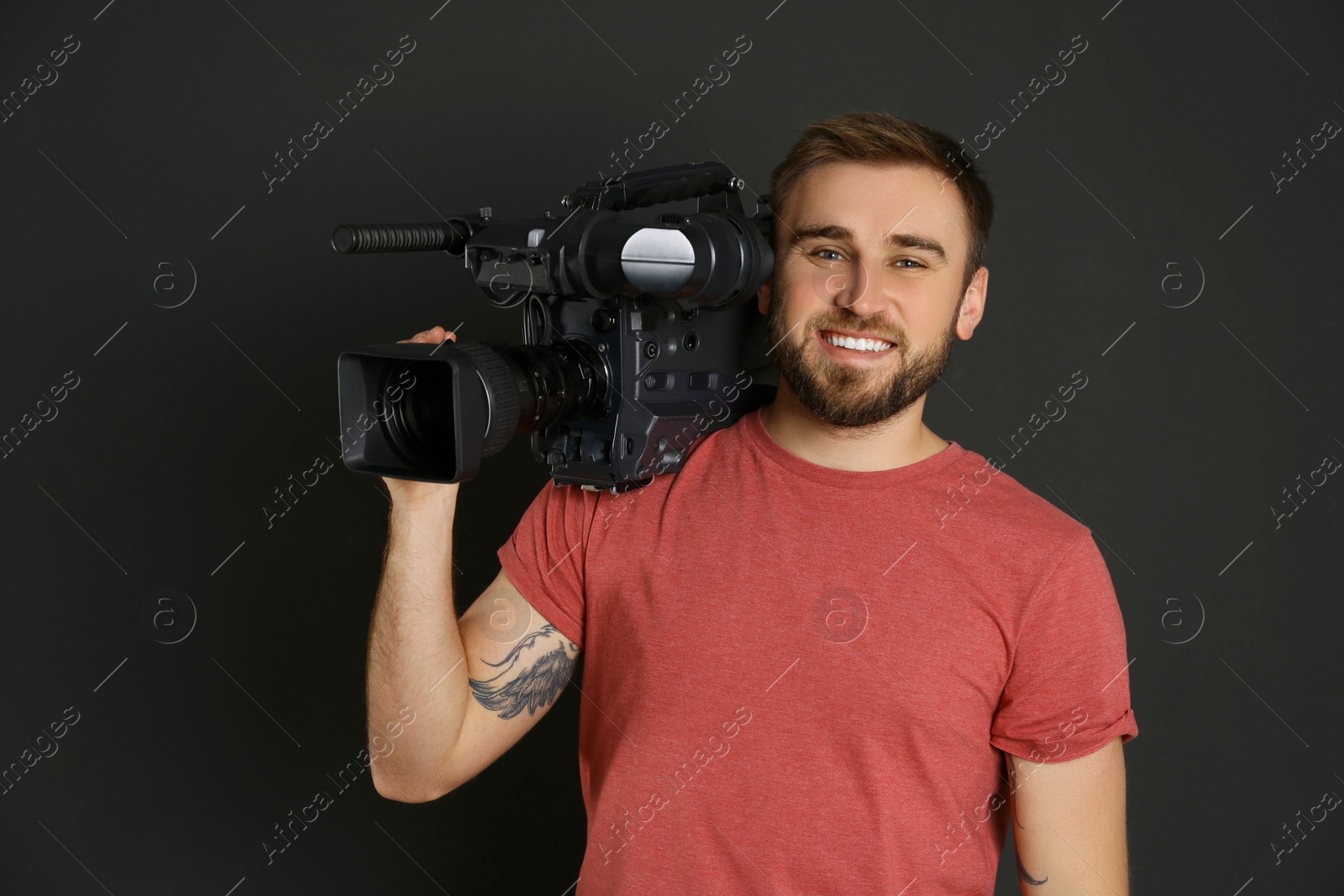 Photo of Operator with professional video camera on black background