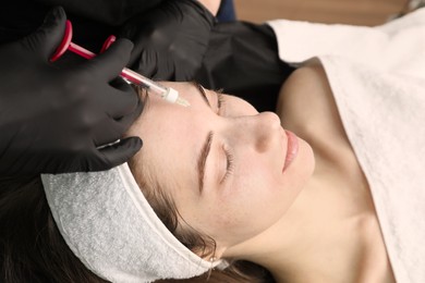 Photo of Cosmetologist giving facial injection to patient, closeup. Cosmetic surgery