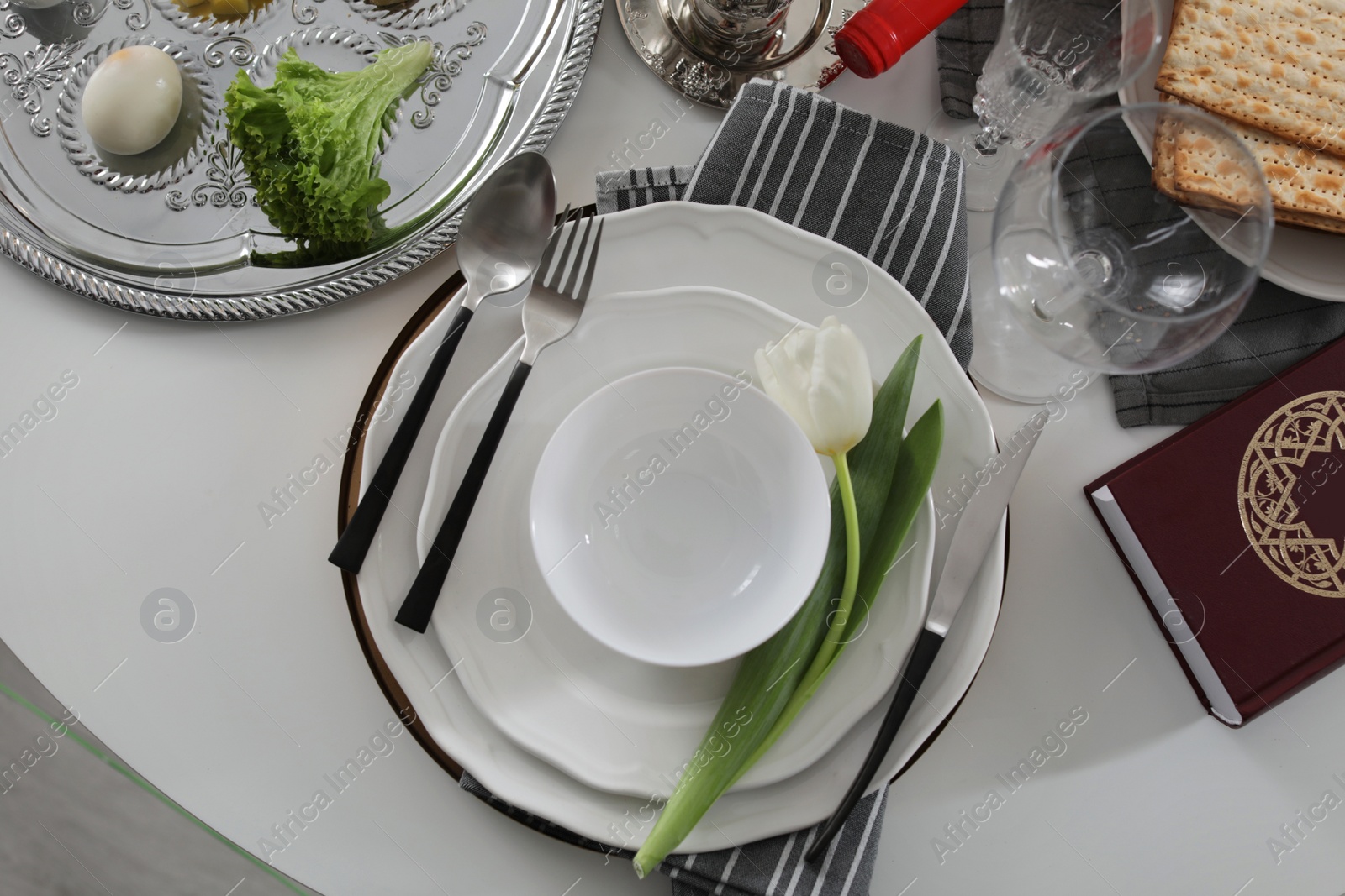 Photo of Festive Passover table setting with Torah, top view. Pesach celebration