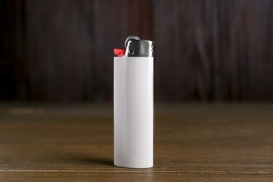 Stylish small pocket lighter on wooden table