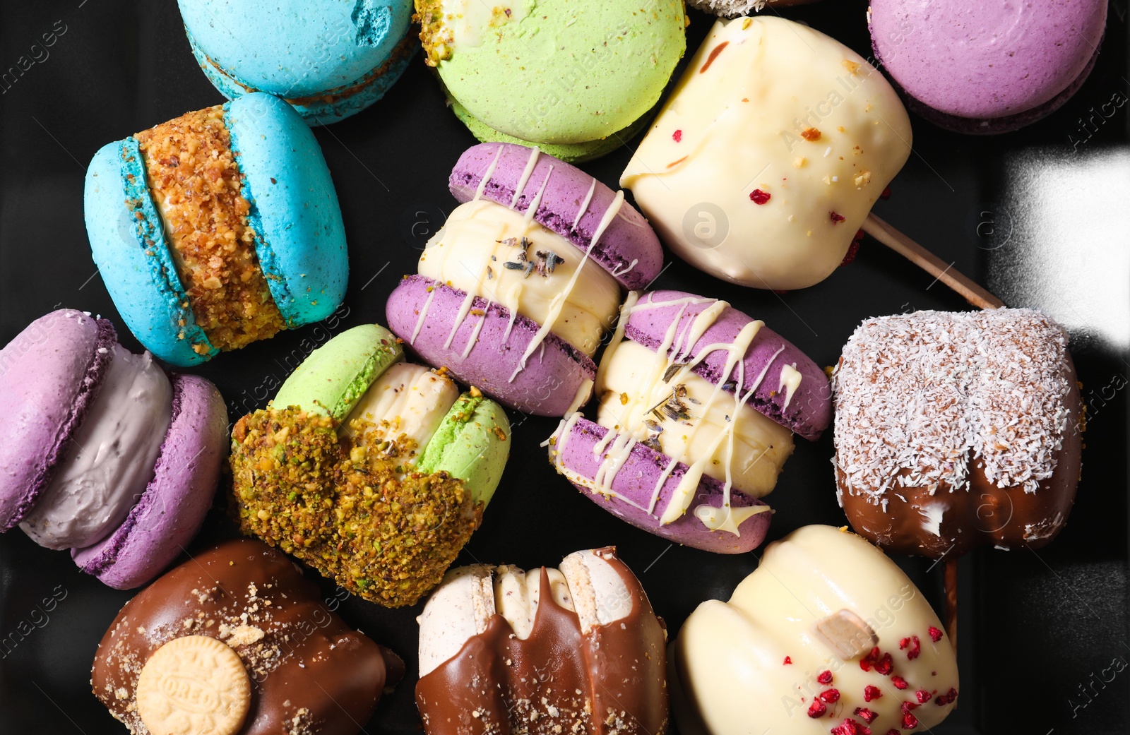 Photo of Delicious colorful macarons on table, top view