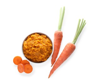 Delicious vegetable puree and fresh carrots on white background, top view. Healthy food