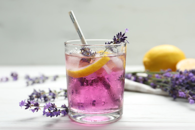 Photo of Fresh delicious lemonade with lavender on white wooden table