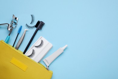 Photo of Flat lay composition with fake eyelashes on light blue background, space for text