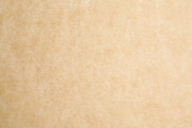 Photo of Texture of brown baking paper as background, closeup
