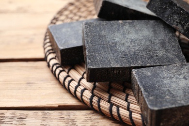 Natural tar soap on wooden table, closeup