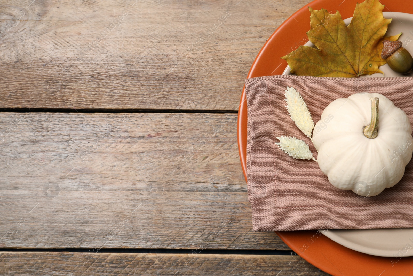 Photo of Festive table setting with autumn decor on wooden background, top view. Space for text