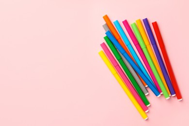 Photo of Many bright markers on pink background, flat lay. Space for text