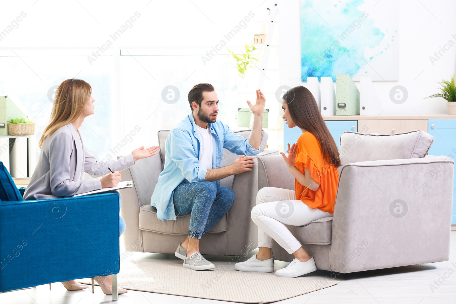 Photo of Family psychologist working with young couple in office