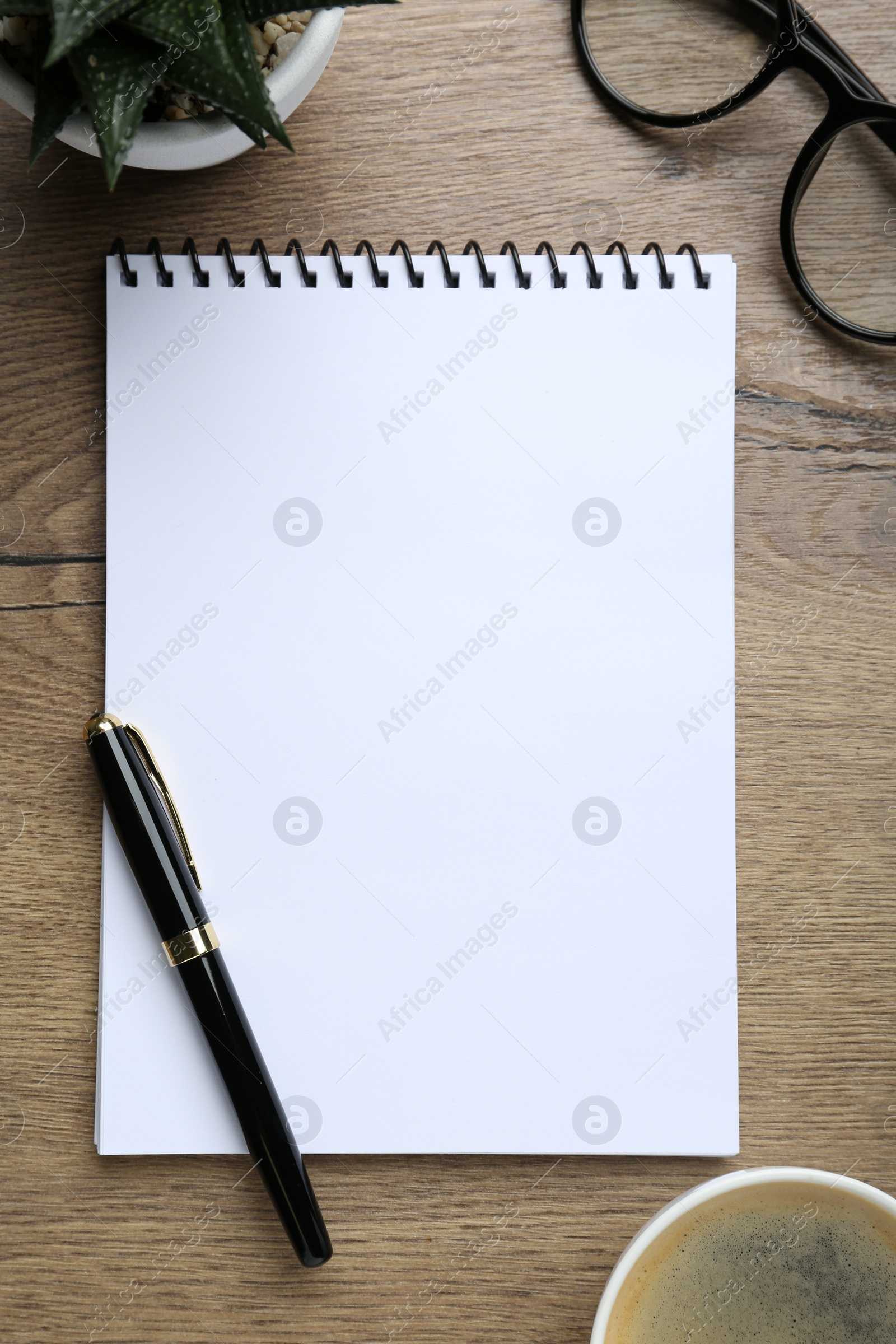Photo of Flat lay composition with notebook on wooden table