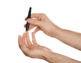 Photo of Man using lancet pen on white background. Diabetes test
