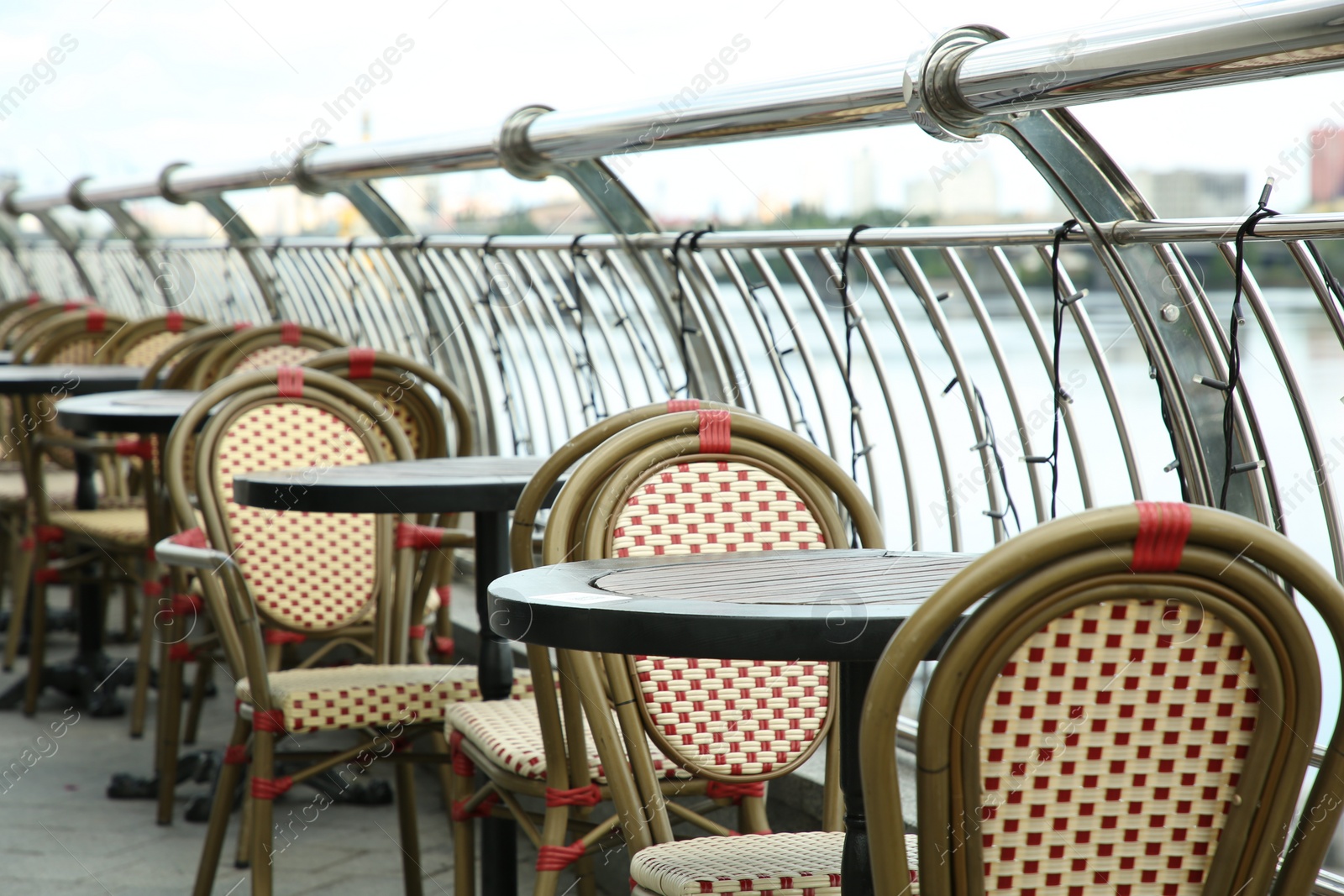 Photo of Stylish chairs and tables on cafe terrace
