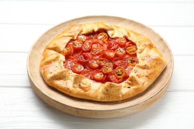 Photo of Tasty tomato galette (Caprese galette) on white wooden table, closeup