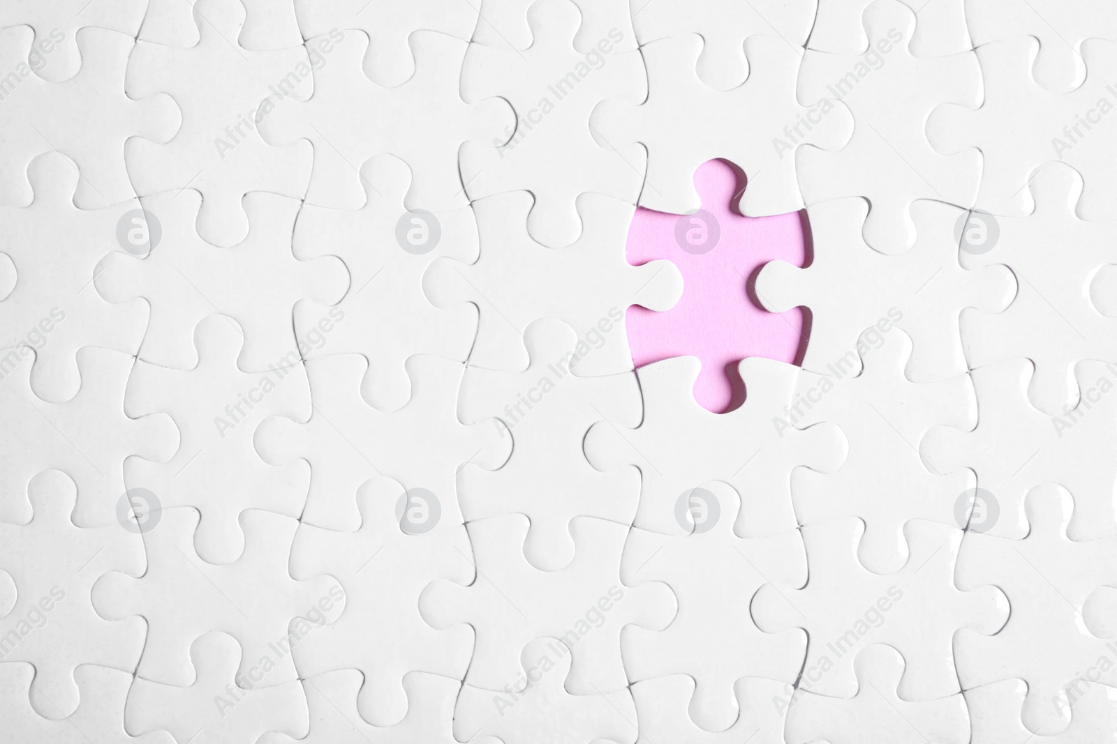 Photo of Blank white puzzle with missing piece on pink background, top view. Space for text