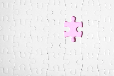 Photo of Blank white puzzle with missing piece on pink background, top view. Space for text