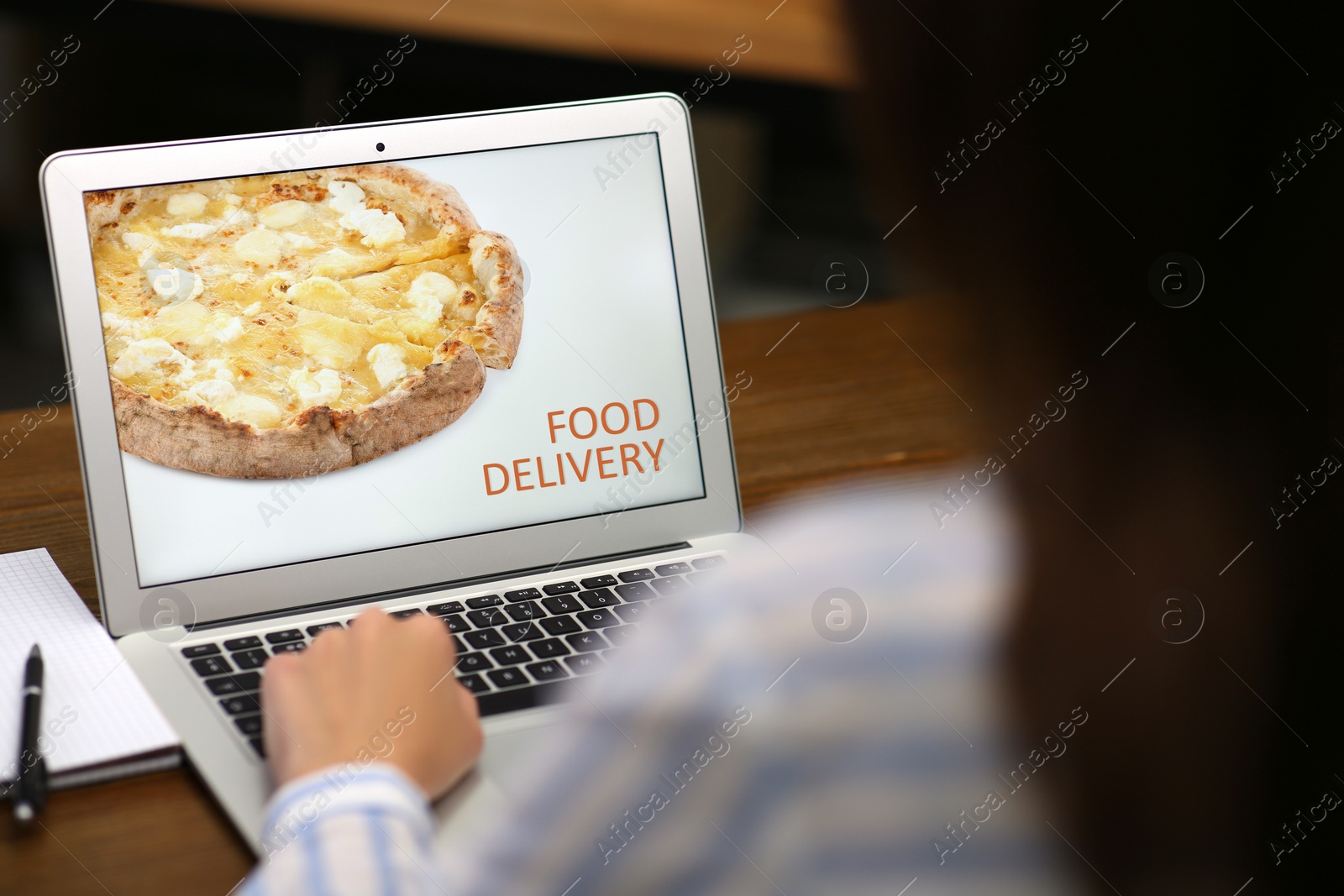 Image of Woman using laptop for online food order during quarantine, closeup. Delivery service