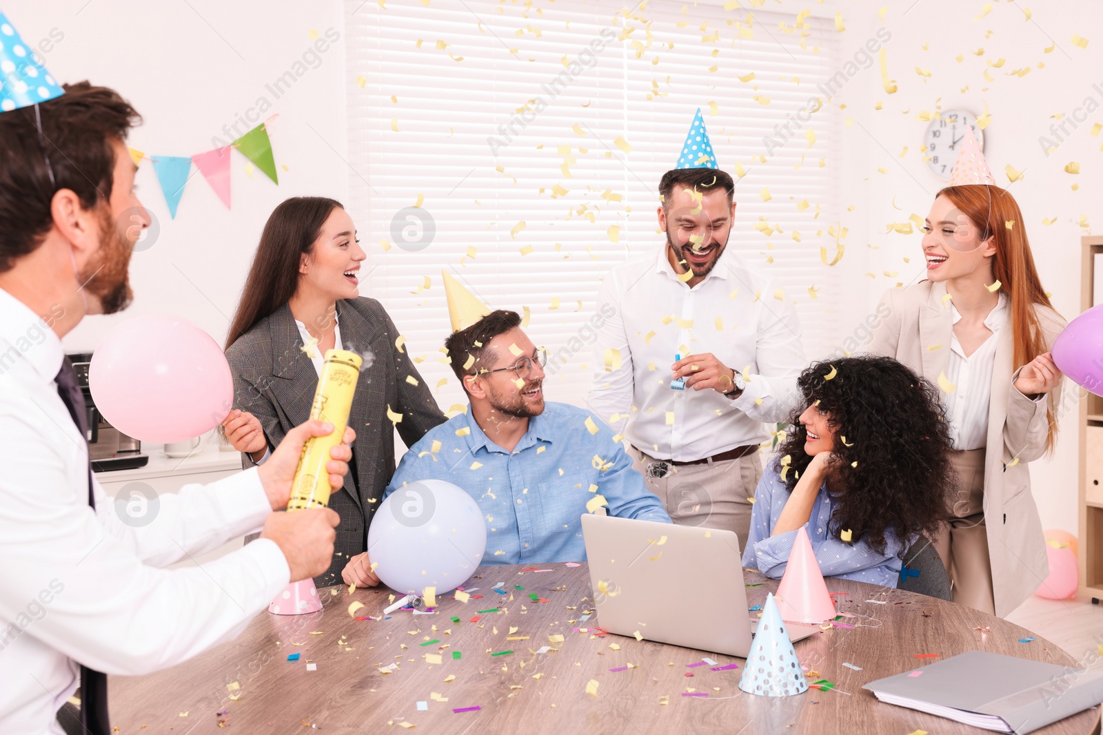 Photo of Coworkers having fun during office party indoors