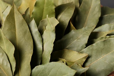 Photo of Aromatic bay leaves as background, closeup view