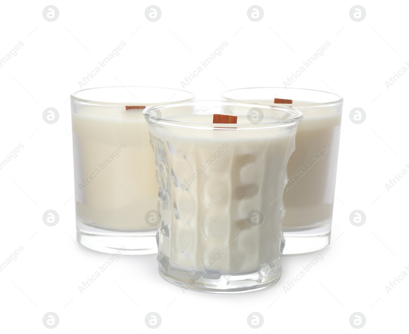 Photo of Aromatic soy candles with wooden wicks on white background