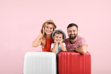 Photo of Happy family with suitcases on color background. Vacation travel