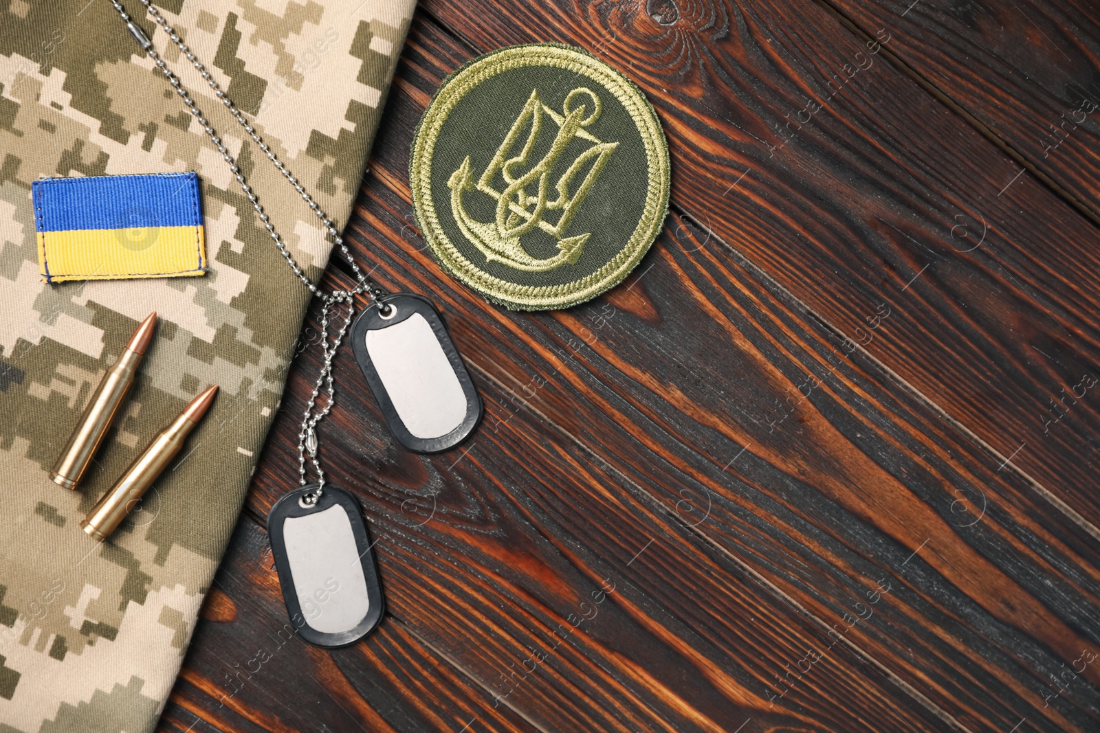 Photo of MYKOLAIV, UKRAINE - SEPTEMBER 19, 2020: Flat lay composition with Ukraine military equipment on wooden table, space for text