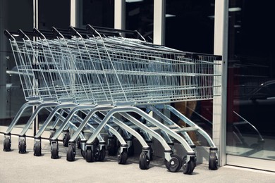 Photo of Row of shopping carts near store outdoors