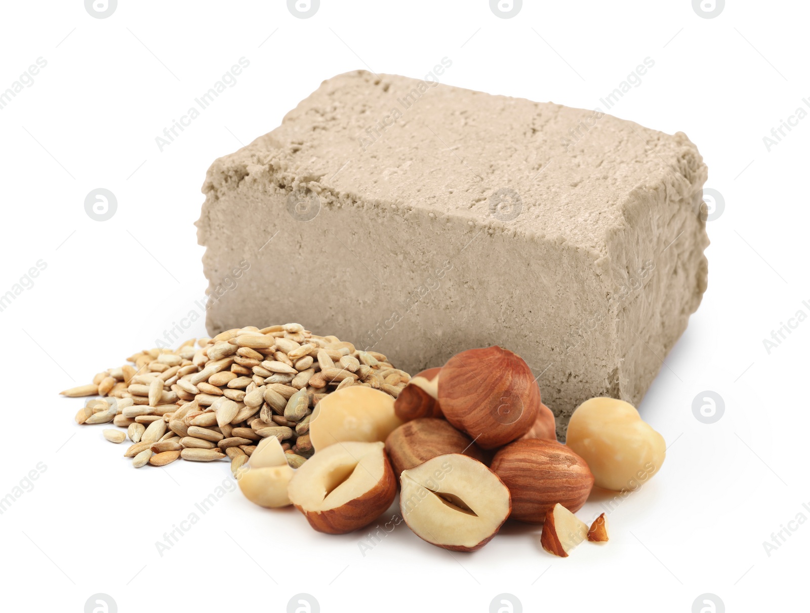 Image of Tasty halva, peeled sunflower seeds and hazelnuts isolated on white