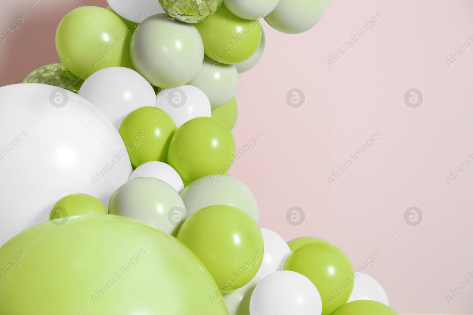 Image of Balloon garland on beige background. Festive decor