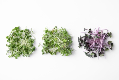 Different fresh microgreens isolated on white, top view