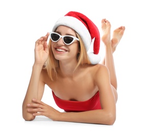 Photo of Young woman wearing Santa Claus hat on white background. Christmas vacation