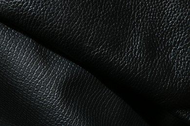 Photo of Black natural leather as background, top view