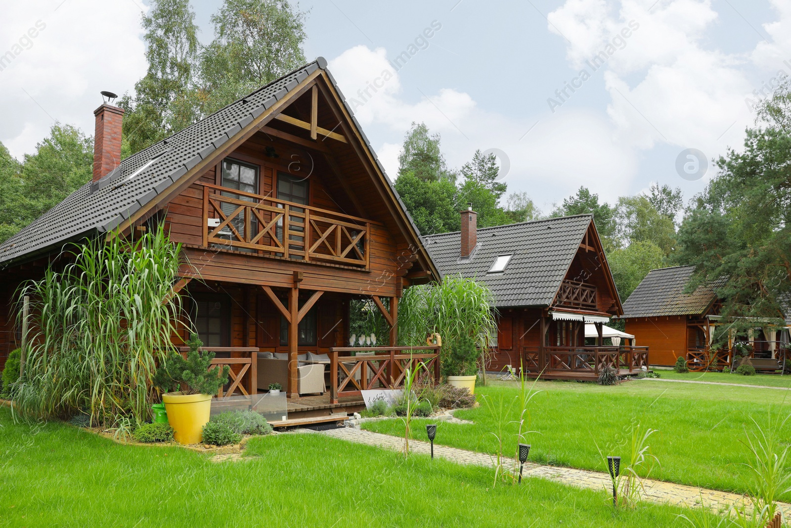 Photo of Beautiful view of wooden summer houses with porches