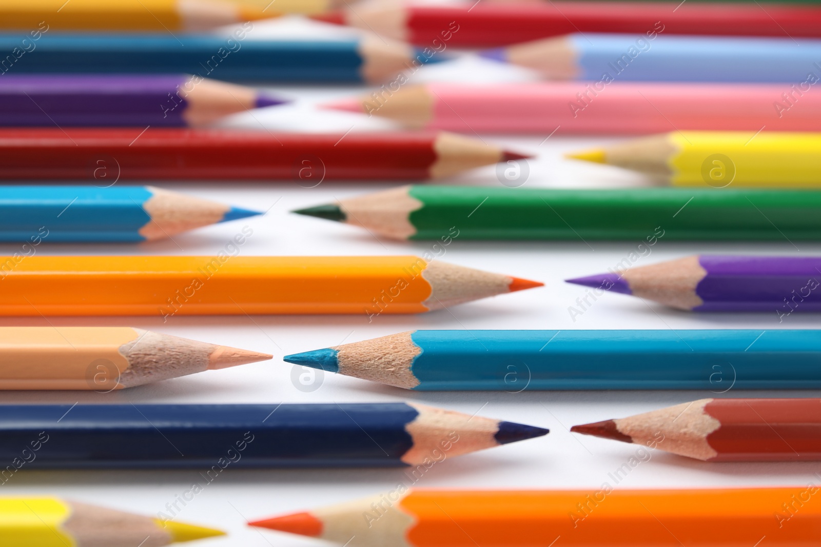 Photo of Composition with color pencils on white background, closeup