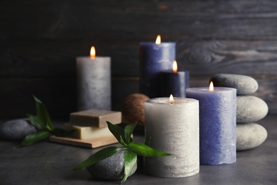 Photo of Spa composition with burning candles on table, space for text