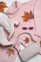 Photo of Fall and winter fashion. Layout with woman's outfit on white background, top view