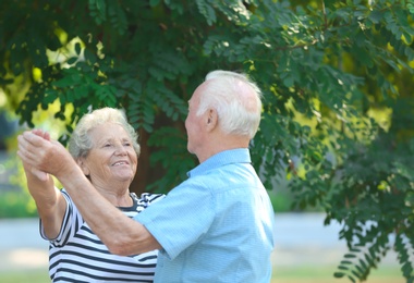 Photo of Cute elderly couple dancing outdoors. Time together