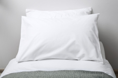 Photo of Bed with soft fluffy pillows at home