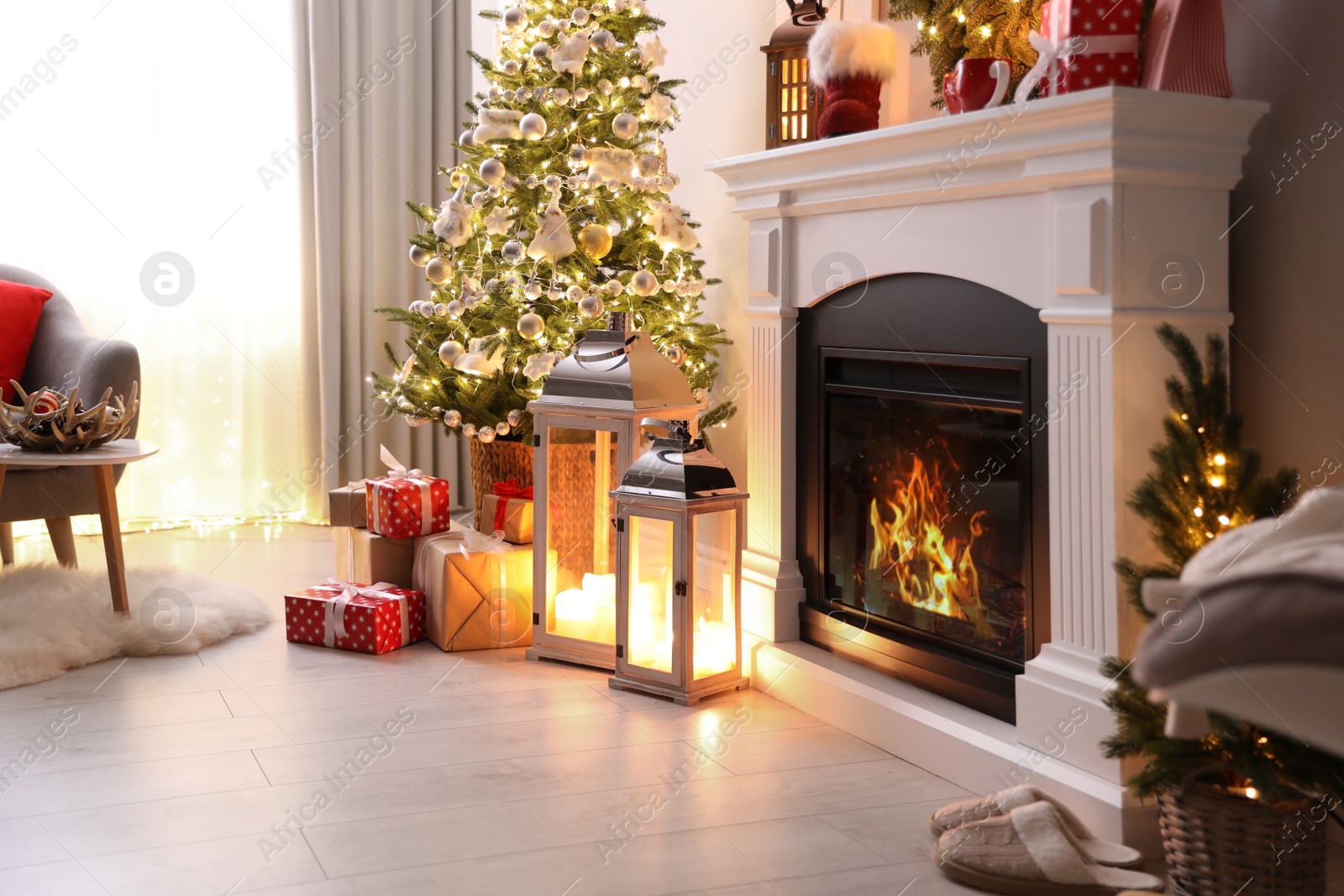 Photo of Stylish living room interior with beautiful fireplace, Christmas tree and other decorations