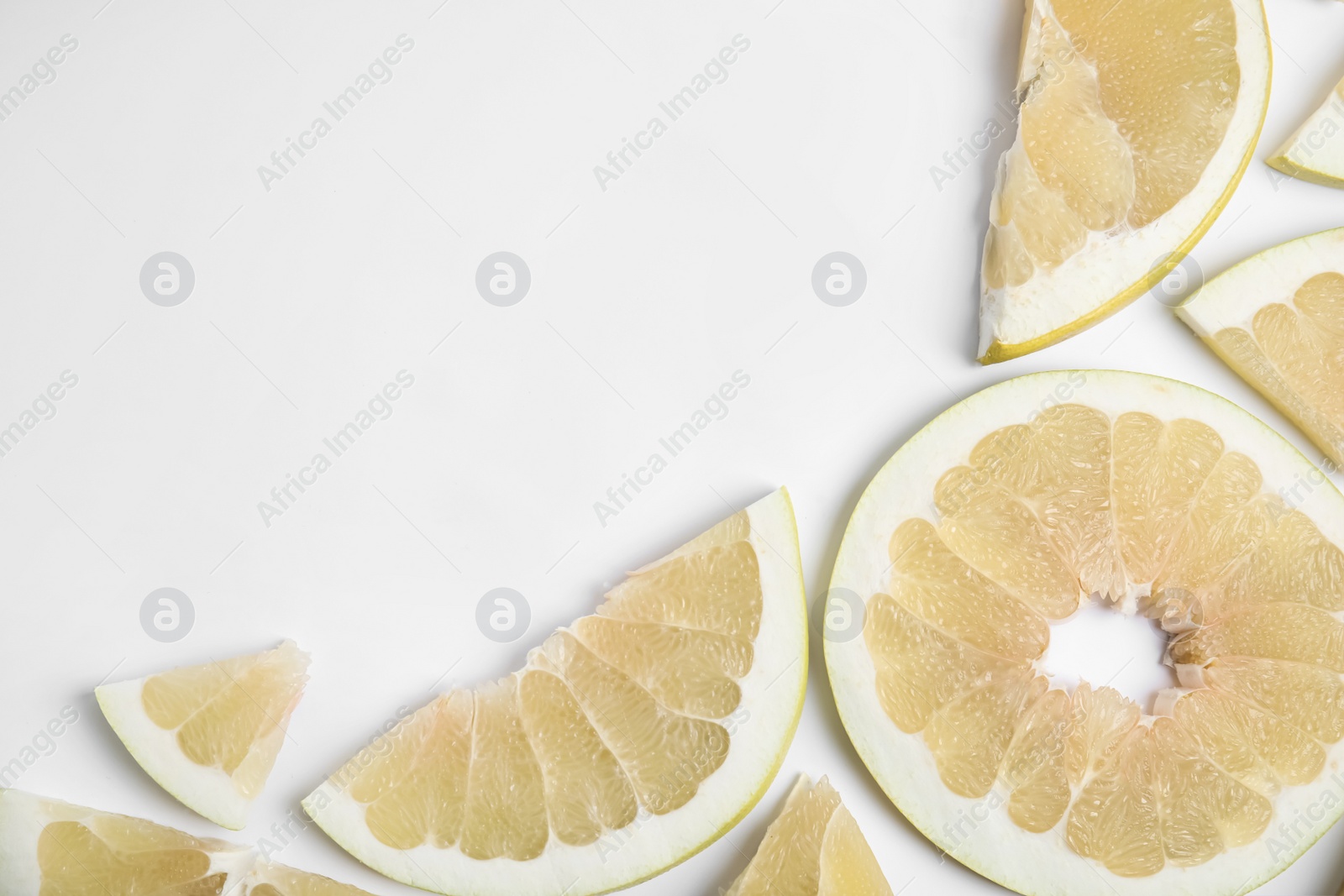 Photo of Slices of delicious ripe pomelo on white background, flat lay. Space for text