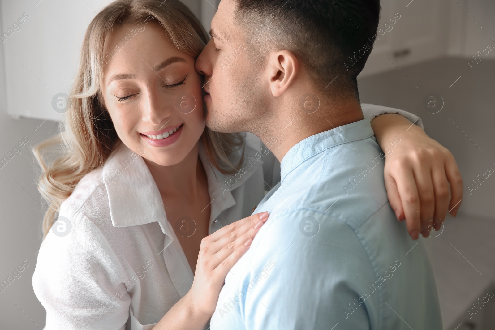 Photo of Lovely couple enjoying time together in kitchen at home